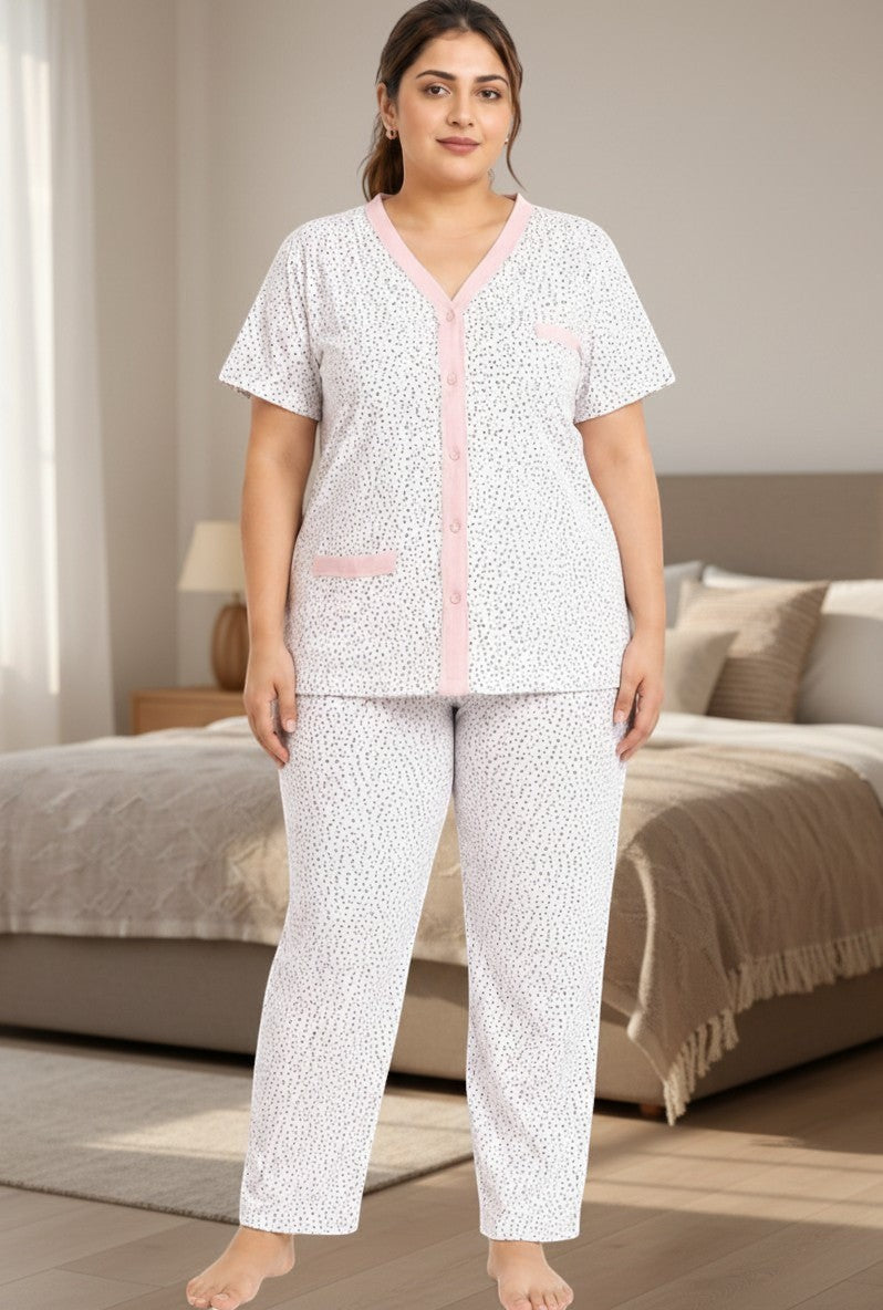 Lifestyle view of a women's cotton pajama set featuring a white and pink patterned design.