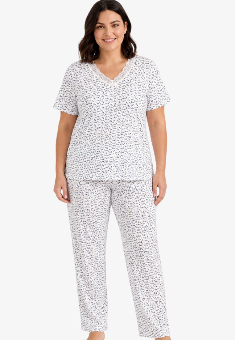 Lifestyle shot of a white pajama set with a relaxed fit and short sleeves.