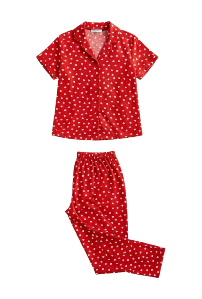 Detail view of a red pajama set with white heart pattern and matching pants.