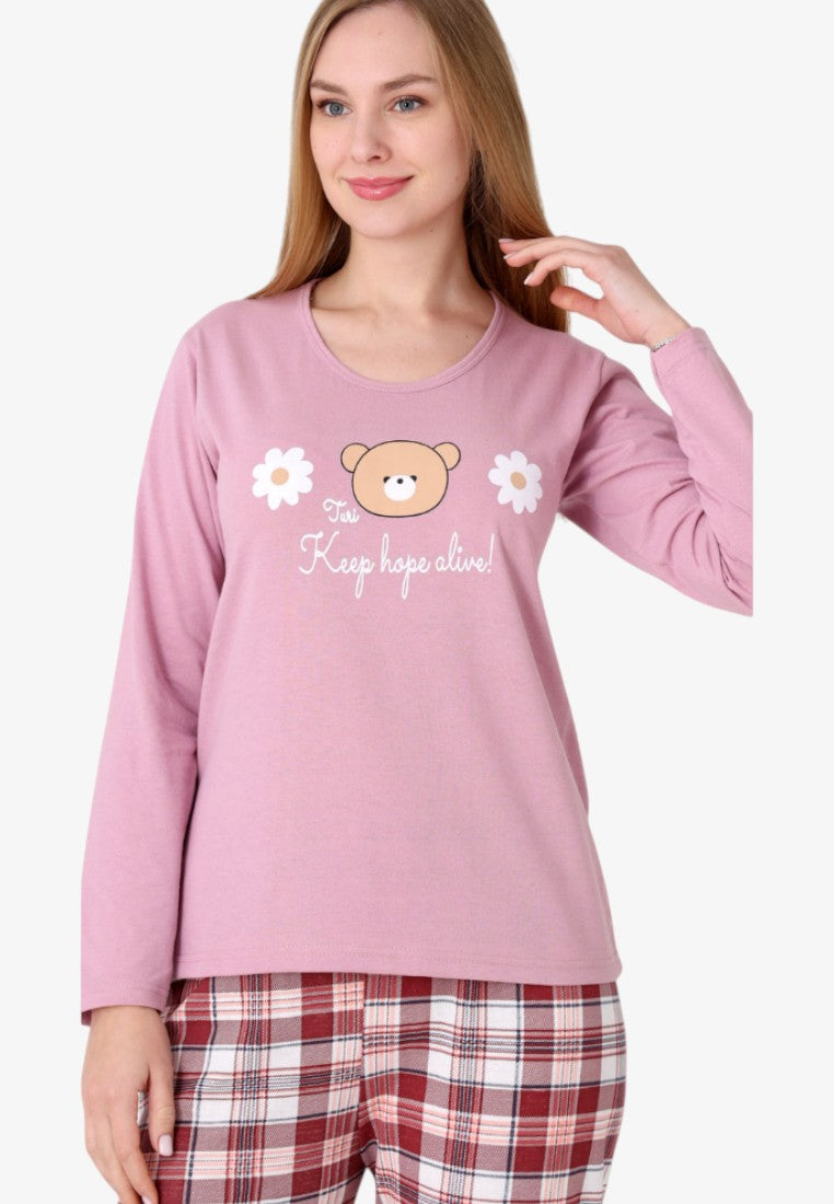 Front view of women's insulated cotton pajama set with pink top and bear graphic, plaid bottoms.