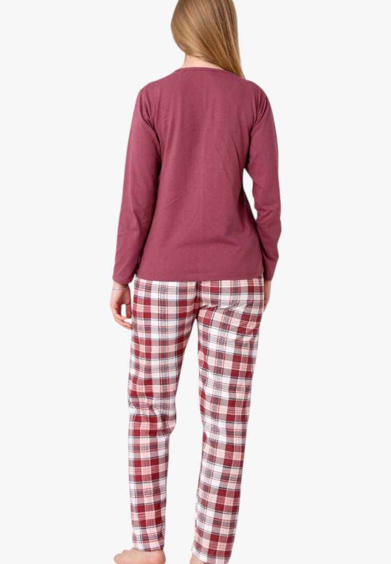 Back view of a woman in a solid maroon long-sleeve pajama top and plaid trousers.