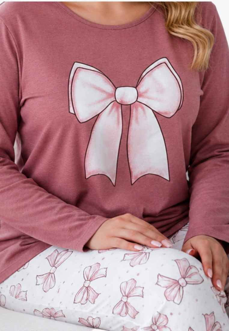 Detail view of pajama set with large bow print on dusty pink top and patterned pants.