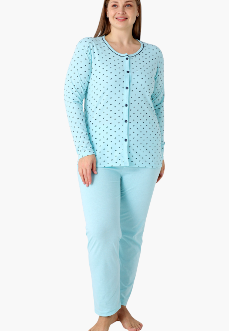 Lifestyle shot of light blue cotton pajama set with long sleeves and heart print.