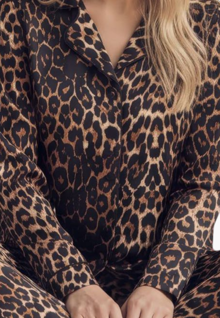 Lifestyle shot of leopard print pajamas with long sleeves on a white background.