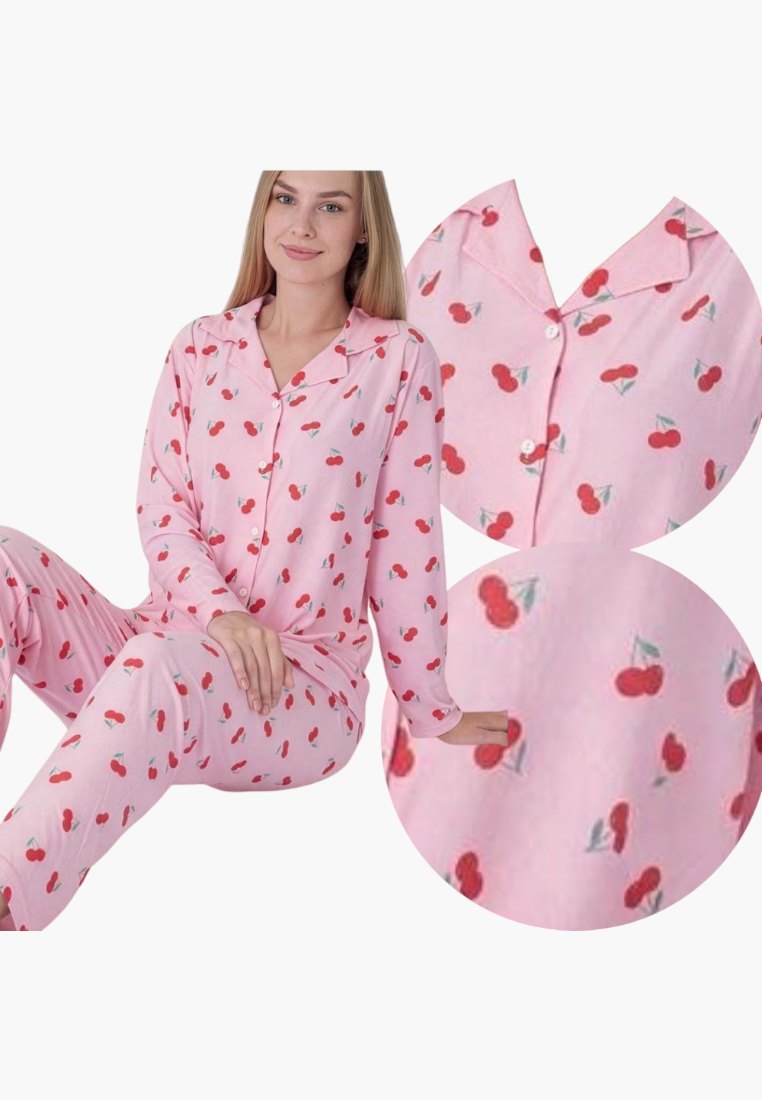 Lifestyle shot of a pink pajama set with strawberry print and button closure.