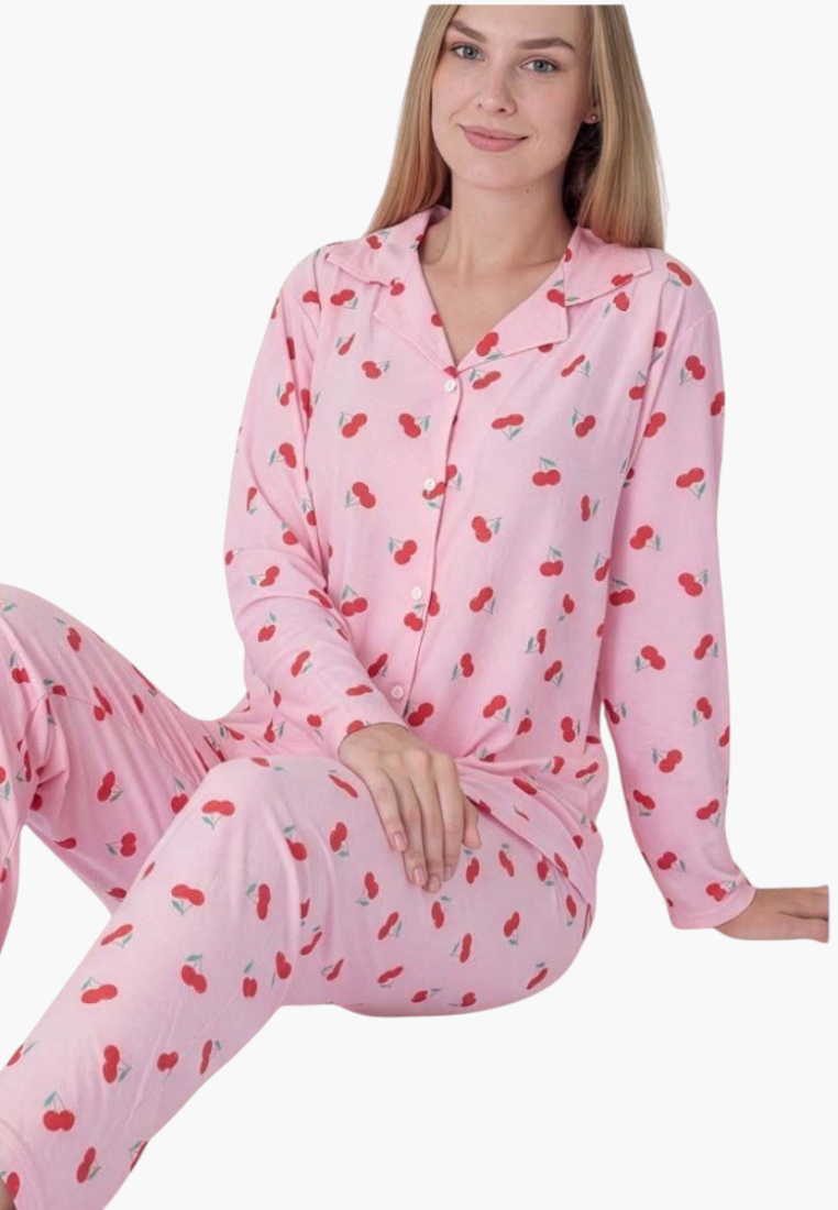 Lifestyle view of a pink pajama set featuring strawberry print and button closure.