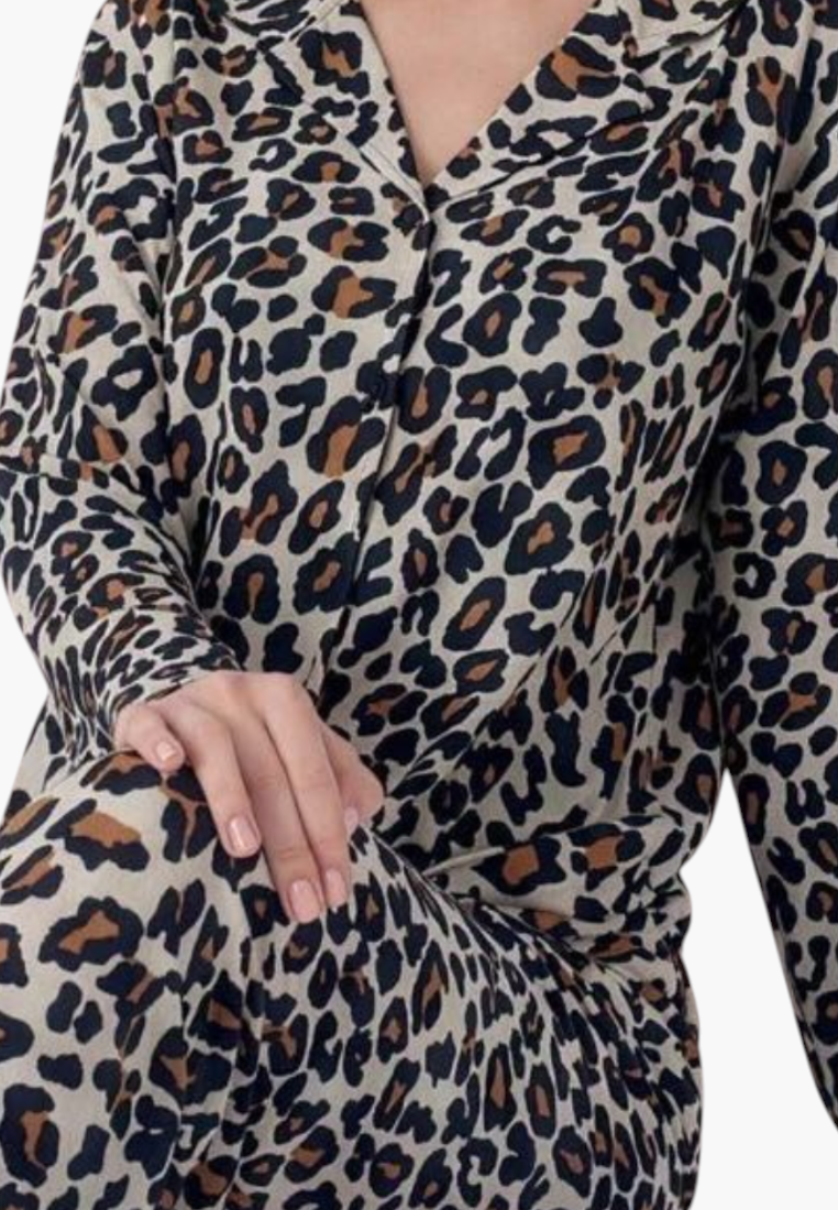 Detail close-up of leopard print pajamas showing soft fabric and v-neck design.