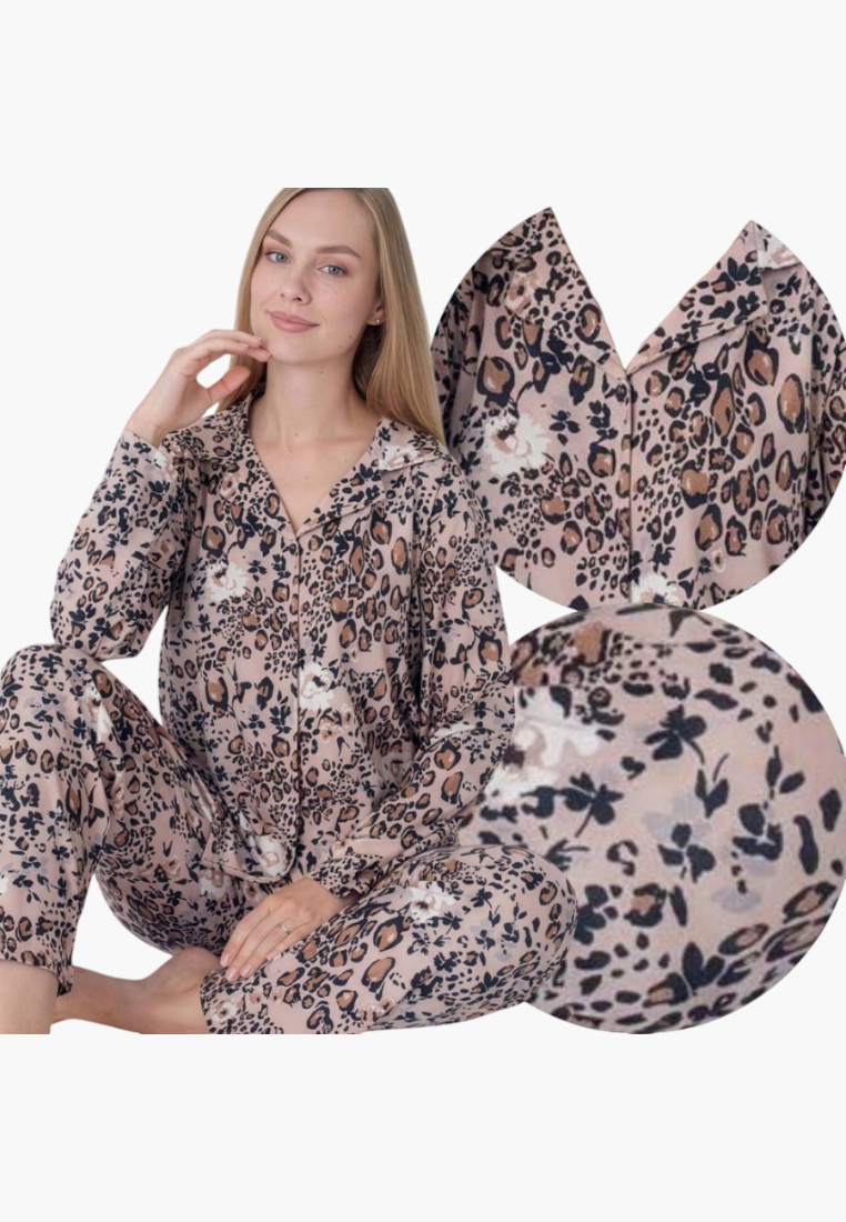 Lifestyle shot of a floral pajama set in pink, blue, and white with long sleeves.