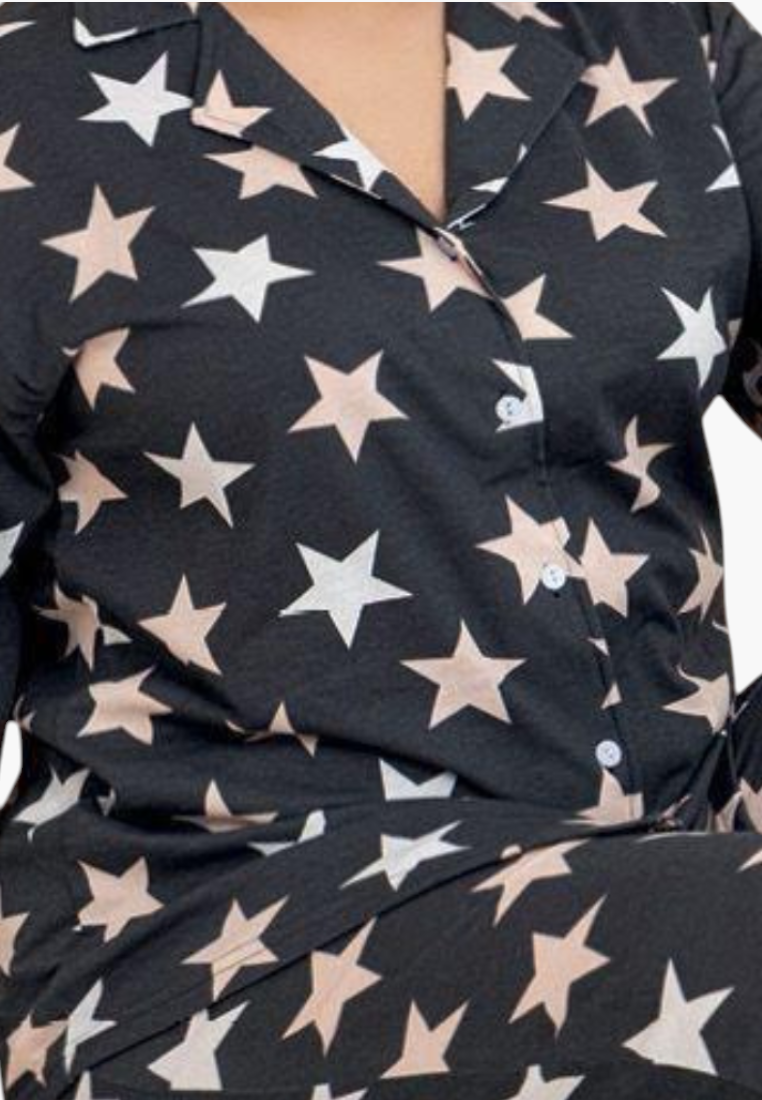 Detail close-up of soft fabric with star print from the navy, pink, and white pajamas.