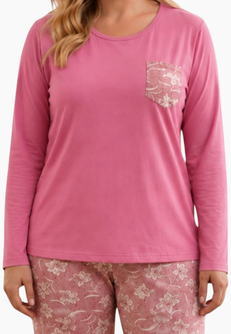 Close-up detail of a pink pajama top featuring a floral design and pocket.