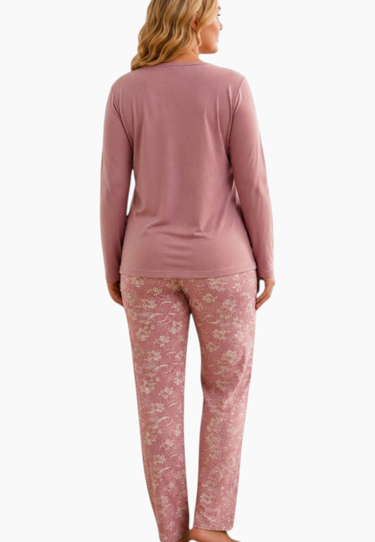 Close-up detail of the women's pajama top in pink and white with floral pattern and pocket detail.