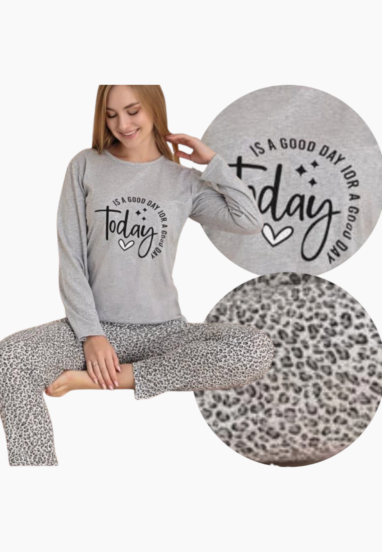 Lifestyle shot of a gray pajama set with long sleeves and printed design.