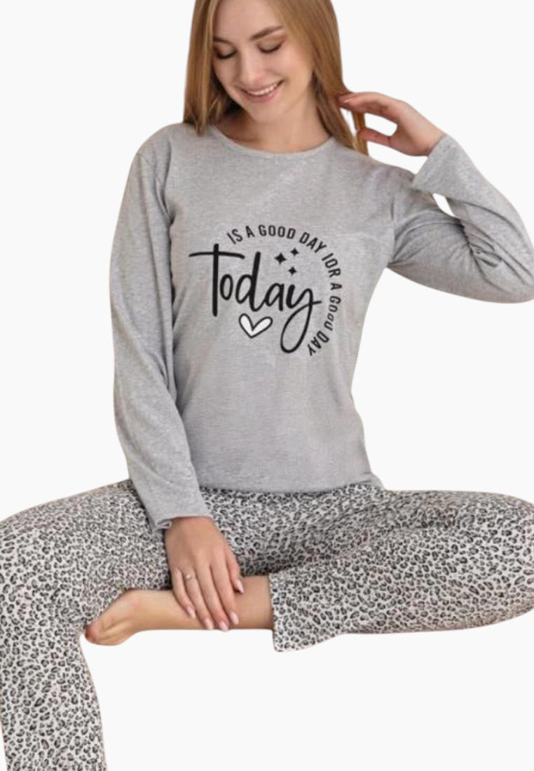 Lifestyle view of a gray pajama set featuring long sleeves and printed design on a white background.