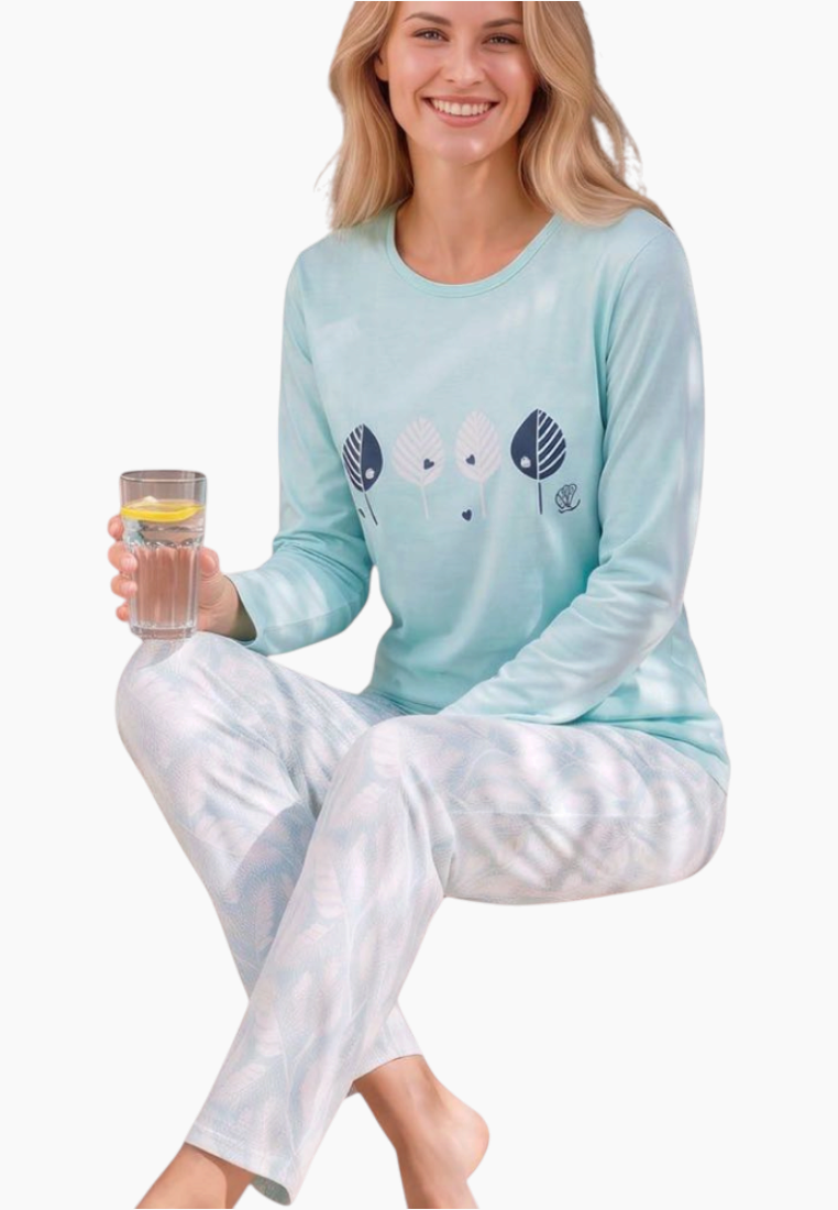 Front view of a woman wearing light blue pajamas with graphic print and long sleeves.