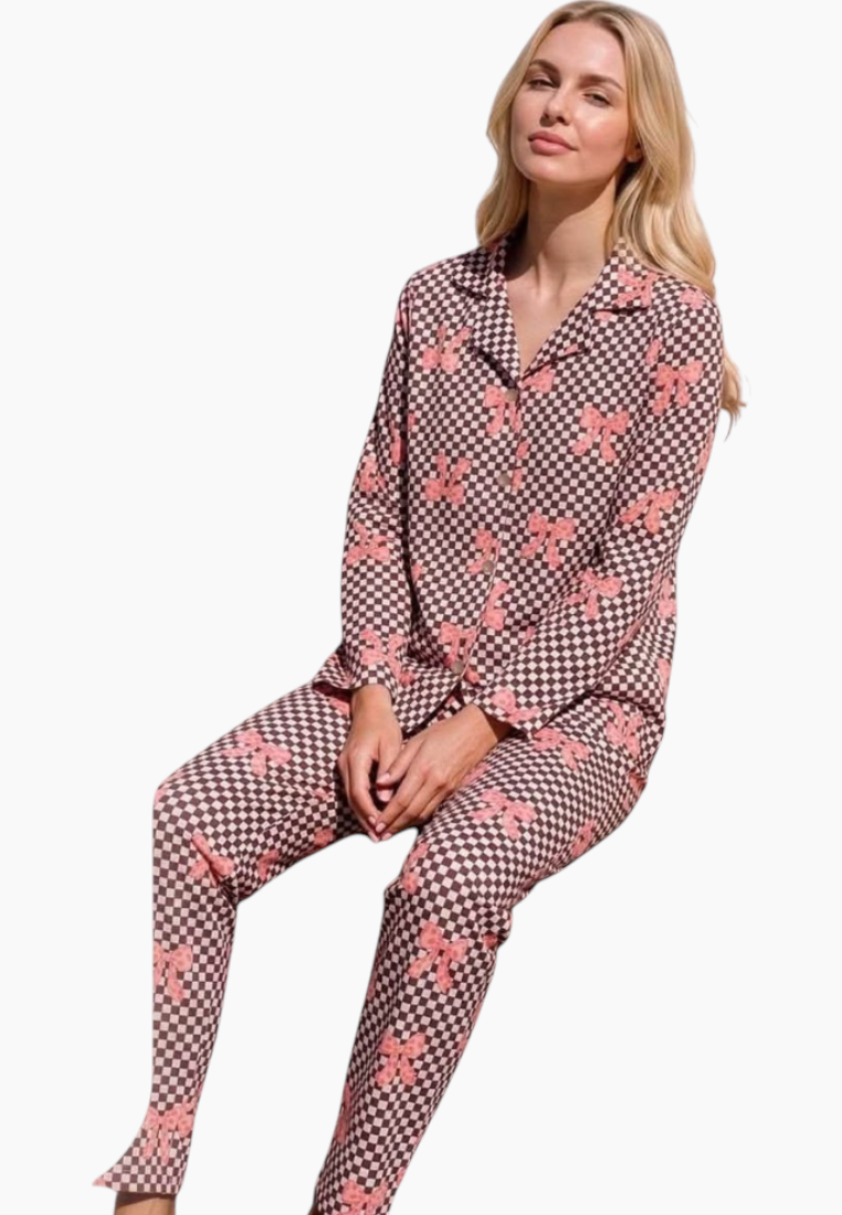 Lifestyle shot of a pink and brown floral pajama set featuring a button-up top.