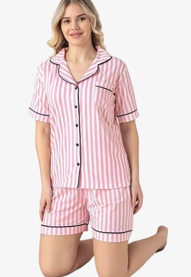 Lifestyle shot of pink striped pajamas featuring short sleeves and button closure.