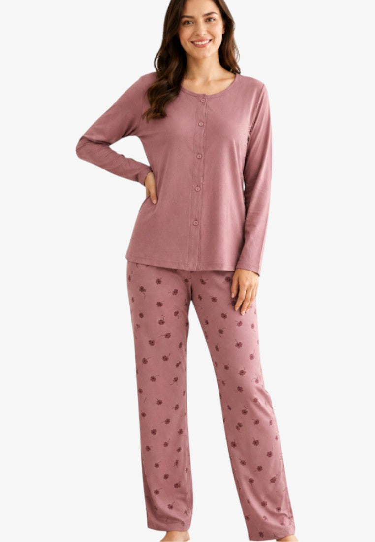 Lifestyle shot of women's mauve pajama set featuring long sleeves and floral print trousers.