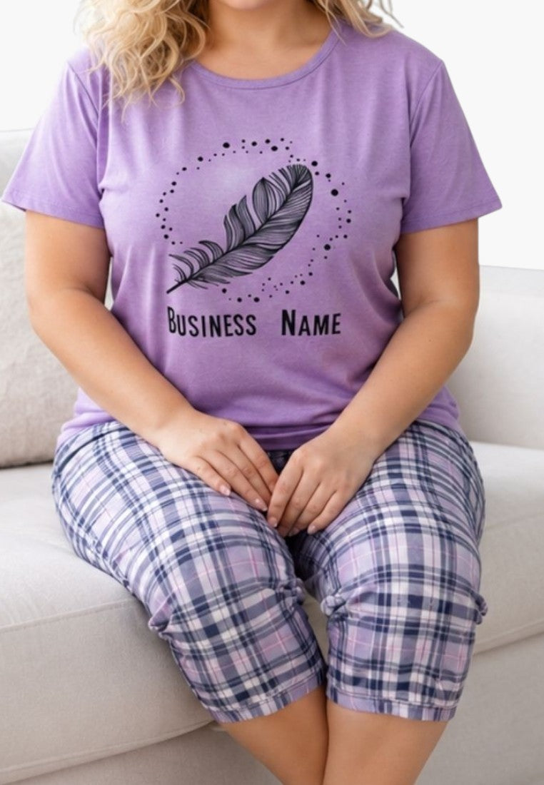 Lifestyle shot of a woman in purple pajamas with plaid pants.