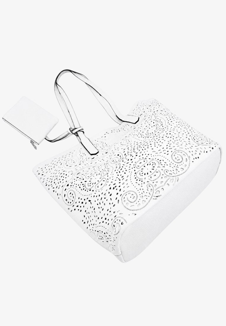 Side view of a minimalist style plain white tote bag with silver handles.