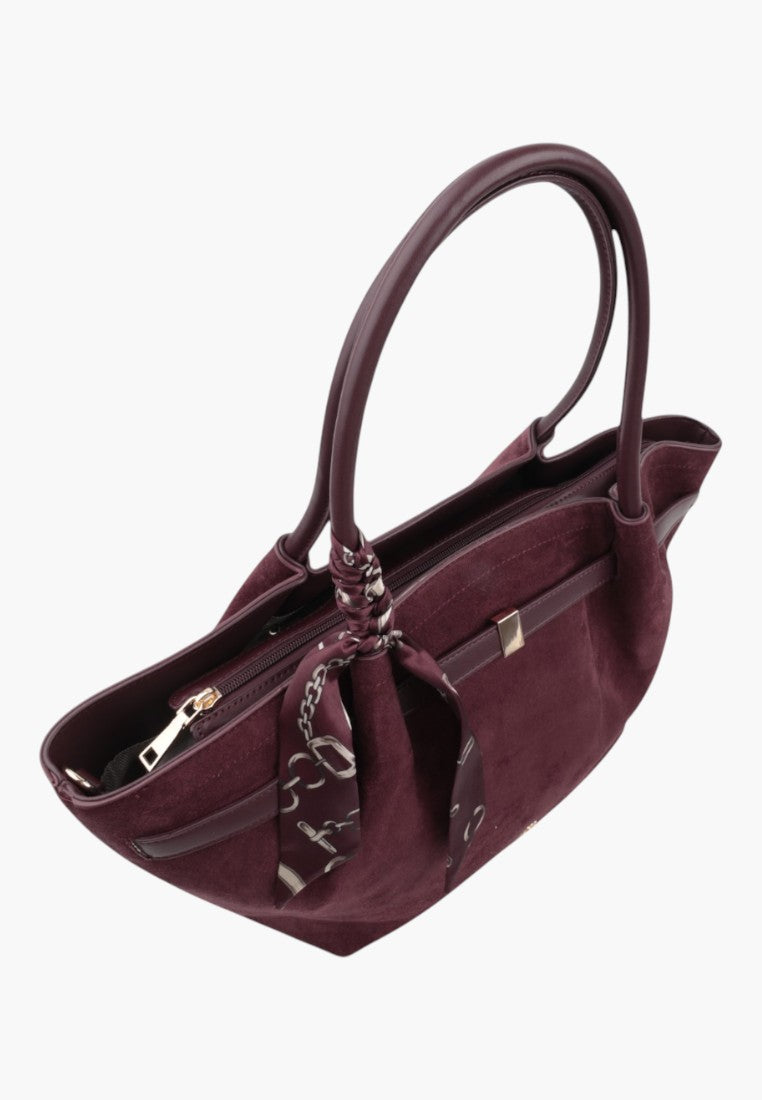 Side view of a burgundy faux suede shopper bag with shoulder straps and zipper closure.