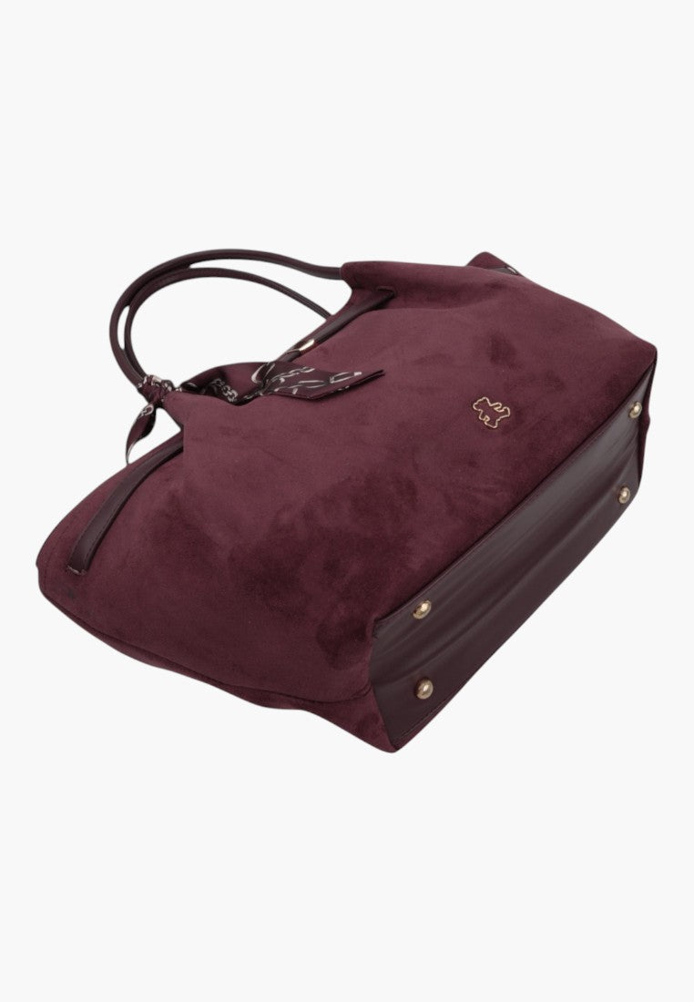 Side view of a spacious burgundy faux suede shopper bag with gold-tone hardware.