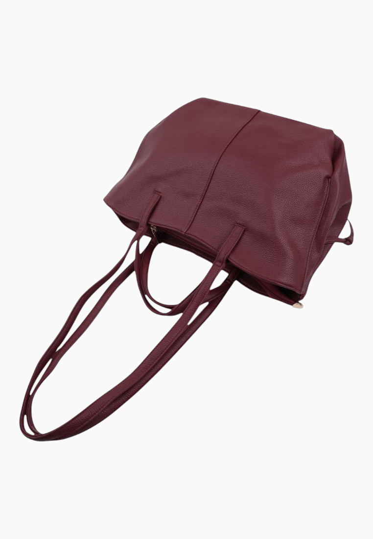 Back view of a burgundy handbag featuring two handles and a spacious design.