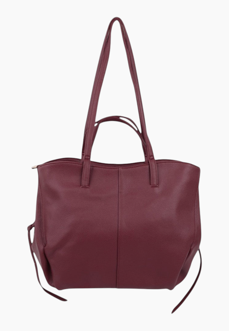 Front view of a burgundy handbag with spacious design and two handles on a white background.