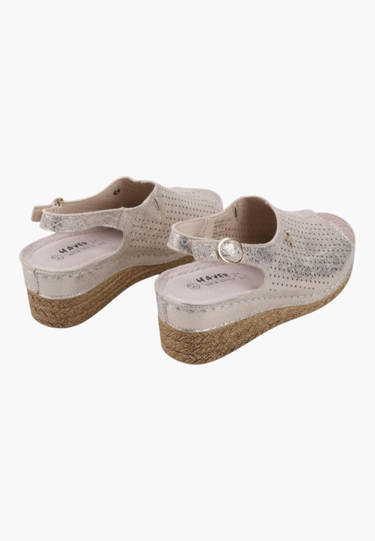 Side view of white platform sandals with open toe and adjustable strap.
