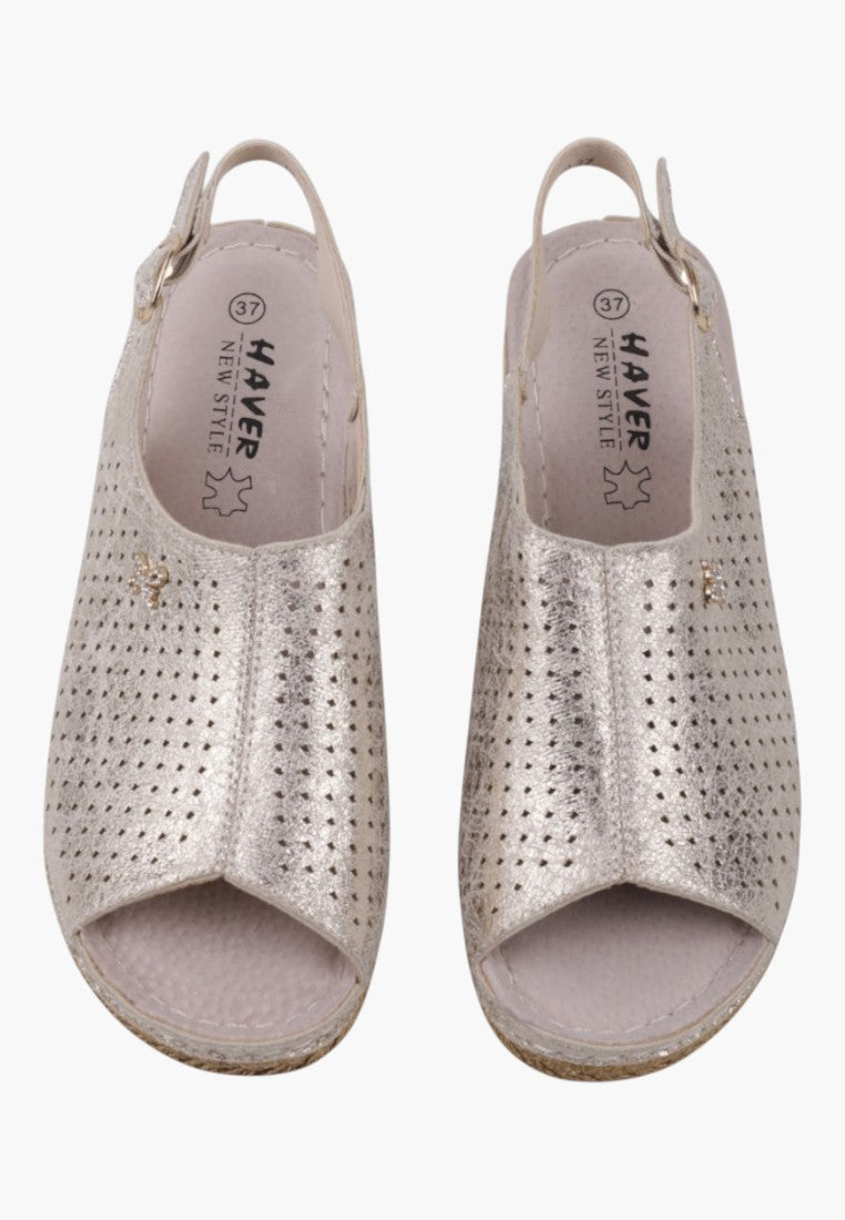 Detail view of wedge sandals in silver and beige showcasing textured upper and comfortable sole.