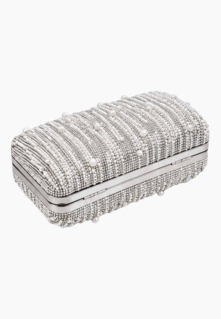 Detail shot of the silver clutch bag displaying the rippled texture and beaded embellishments.