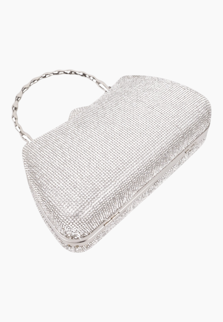 Lifestyle shot of the silver handbag with a beaded handle and crossbody strap.