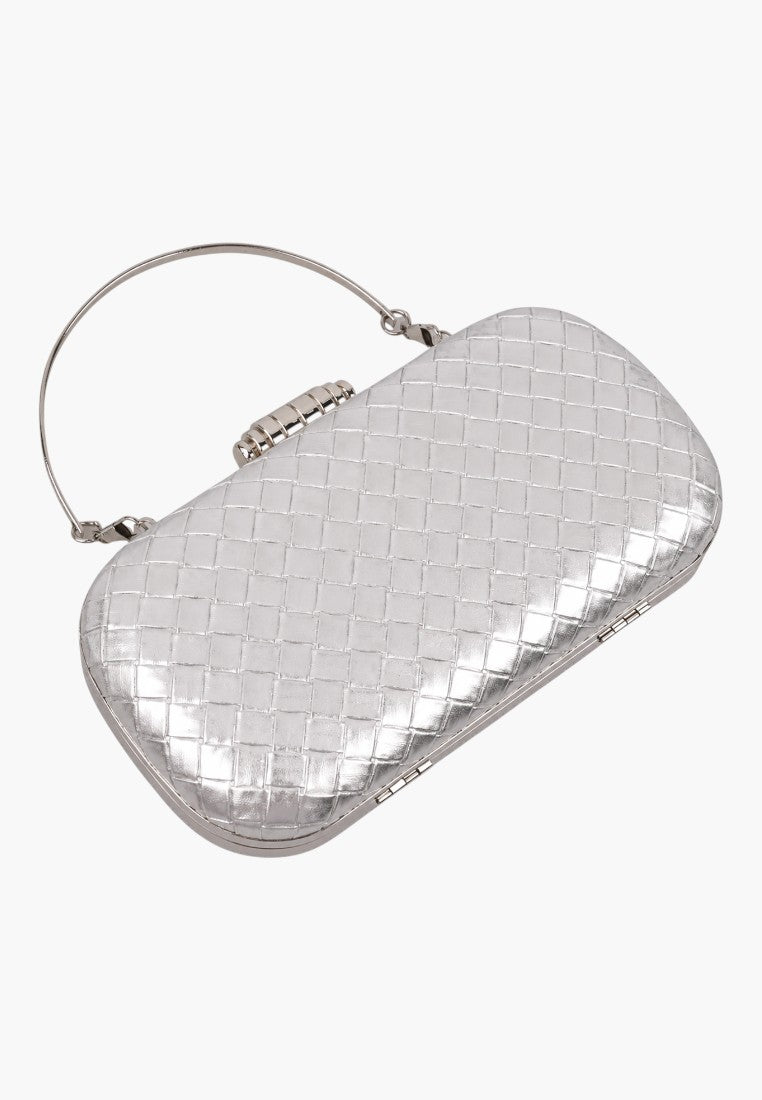 Close-up detail of a silver clutch bag showing its textured surface and metal clasp