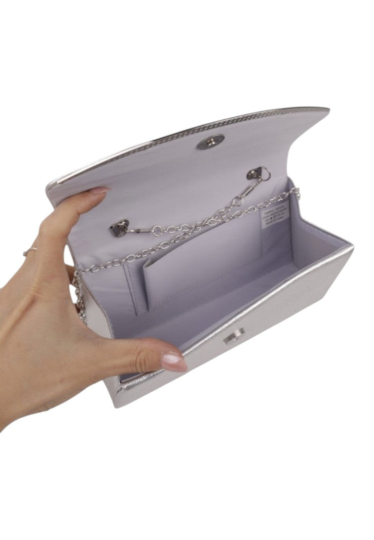 Detail shot of the interior of a silver clutch bag with a chain strap and compartment.