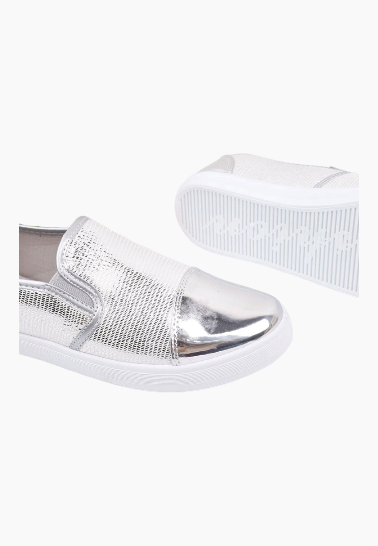 Close-up detail of silver slip-on shoes showcasing metallic finish.