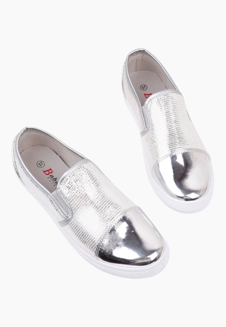 Detail view of silver slip-on shoes featuring an open toe design.