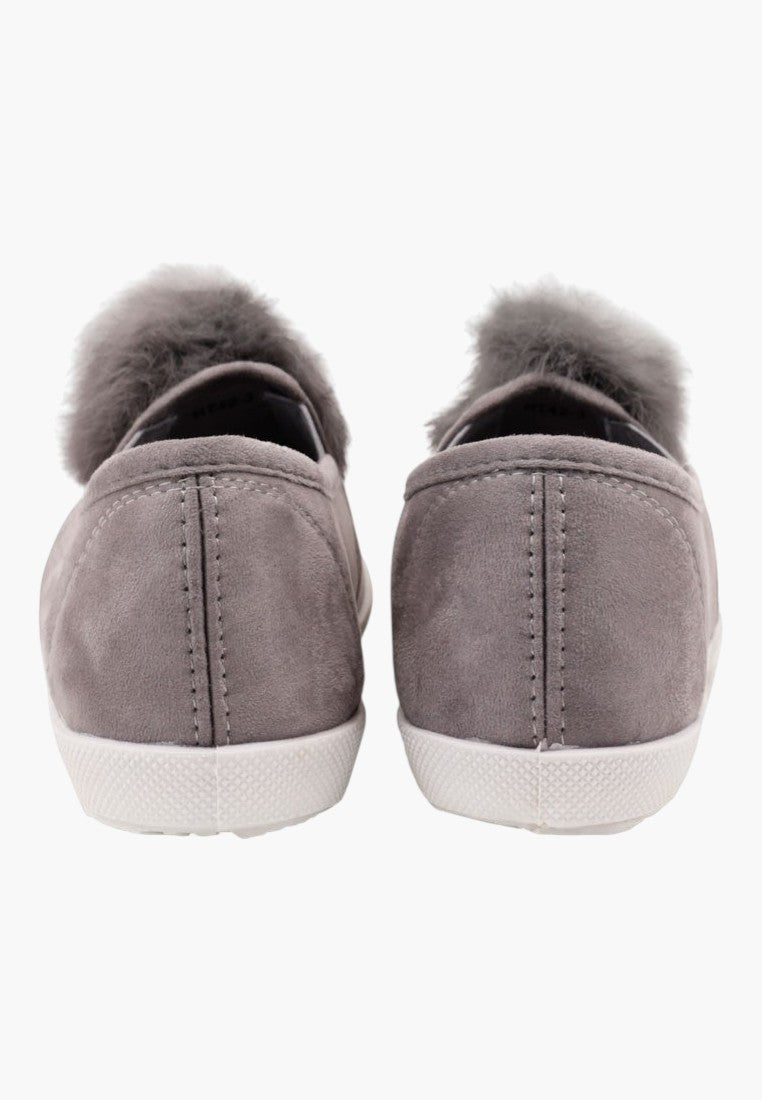 Szare tenisówki slip on z pomponem, stylizacja w życiu codziennym.