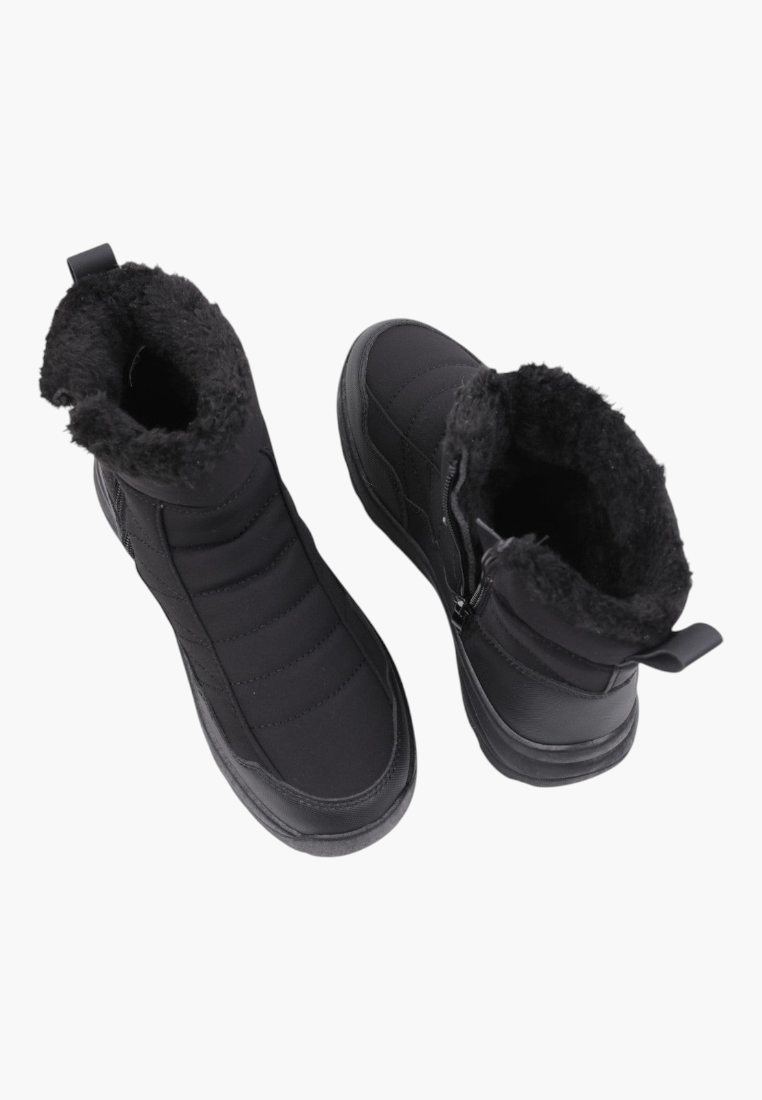 Top view of black ankle boots featuring elastic panels and soft lining.