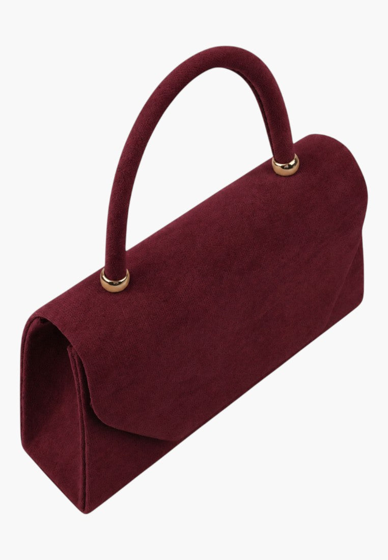 Side view of a structured burgundy handbag with a top handle