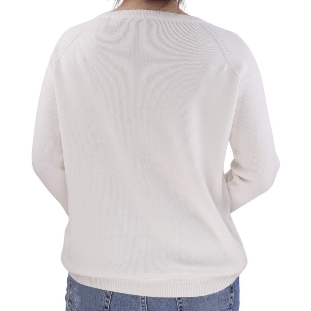Side view of the white long-sleeve top highlighting its design.