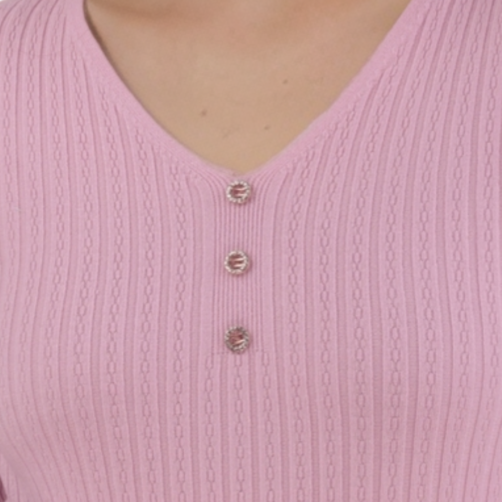 Detail close-up of the pink ribbed top showing button details and ribbed texture.