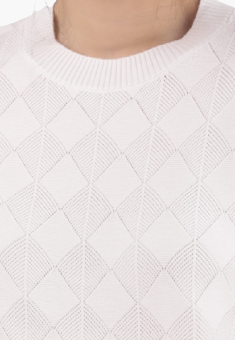 Detail close-up of a white sweater featuring a diamond pattern and crew neck.