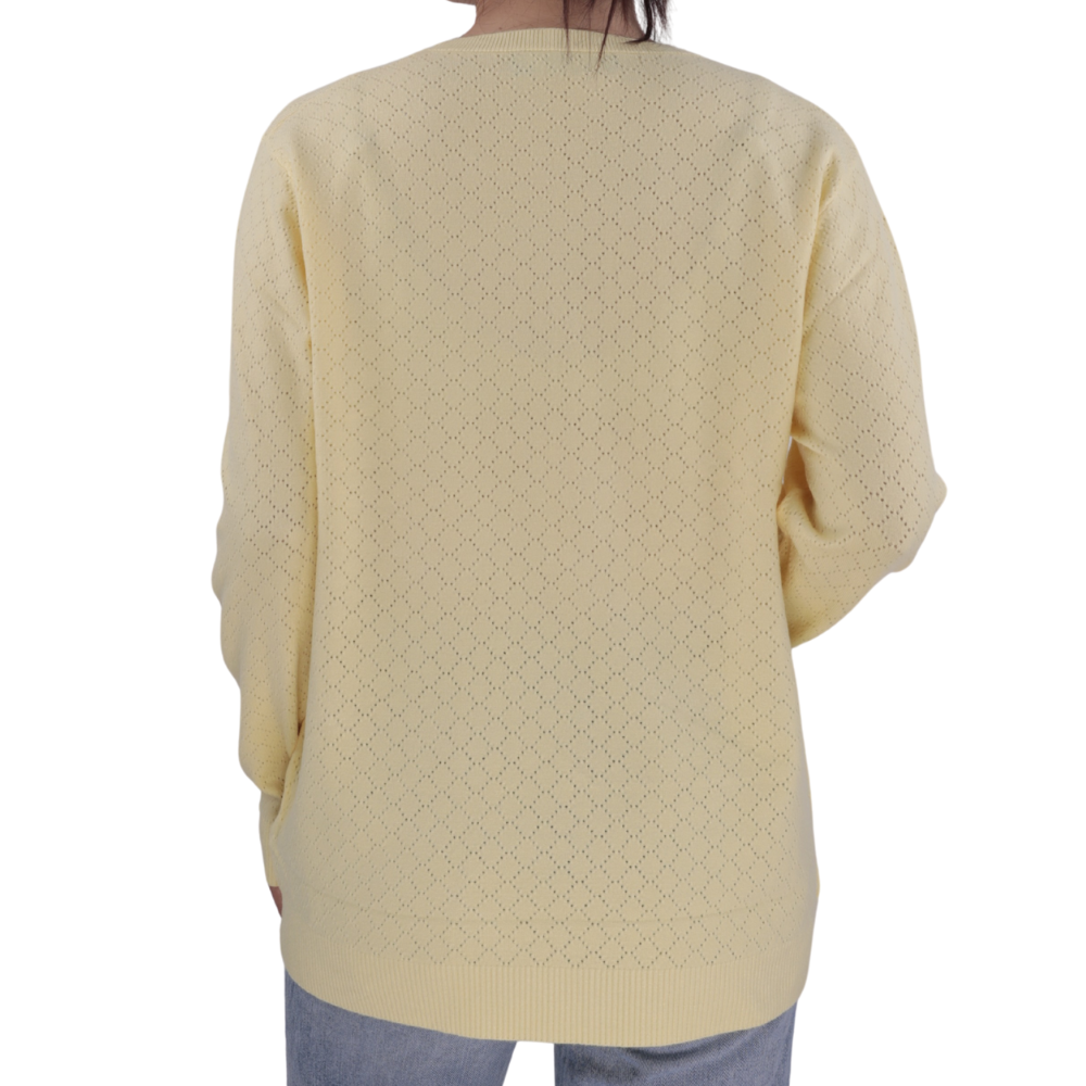 Side view of the yellow long-sleeve sweter with crew neck.