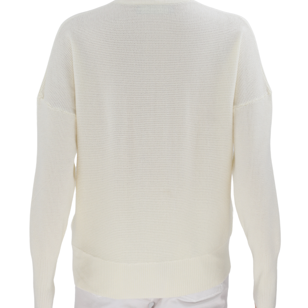 Detail shot of a cream v-neck sweater highlighting pocket detail on a white background.