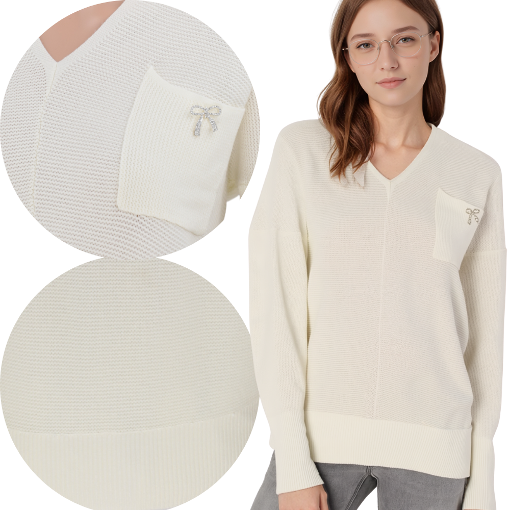 Lifestyle shot of a cream v-neck sweater with pocket detail against a white background.