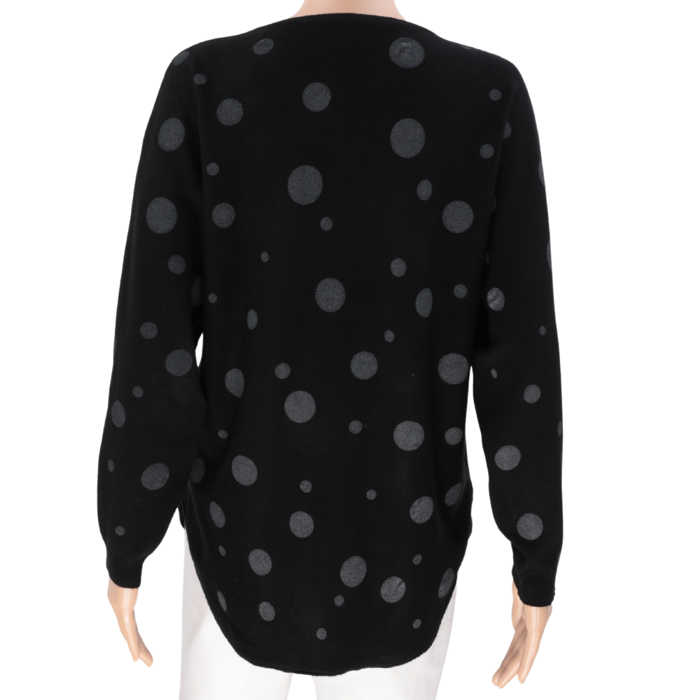 Back view of a black sweater showcasing a polka dot pattern and long sleeves.