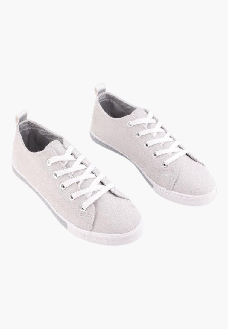 Side view of gray eco-suede sneakers highlighting lace-up design.