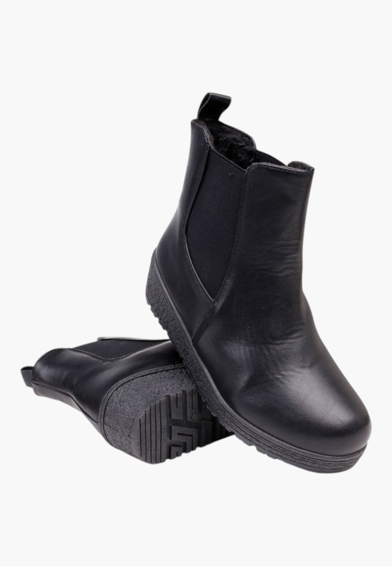 Other view of black ankle boots highlighting removable insole and sturdy construction.