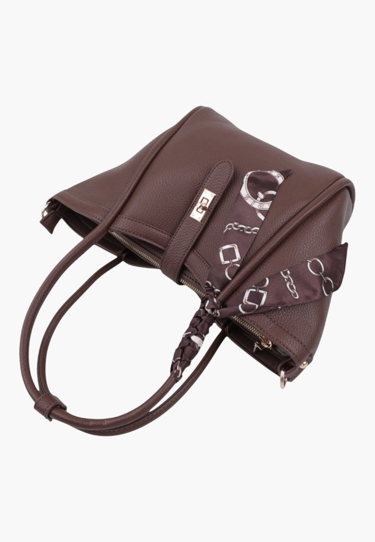 Detail view of taupe faux leather shopper bag with textured surface and logo detail.