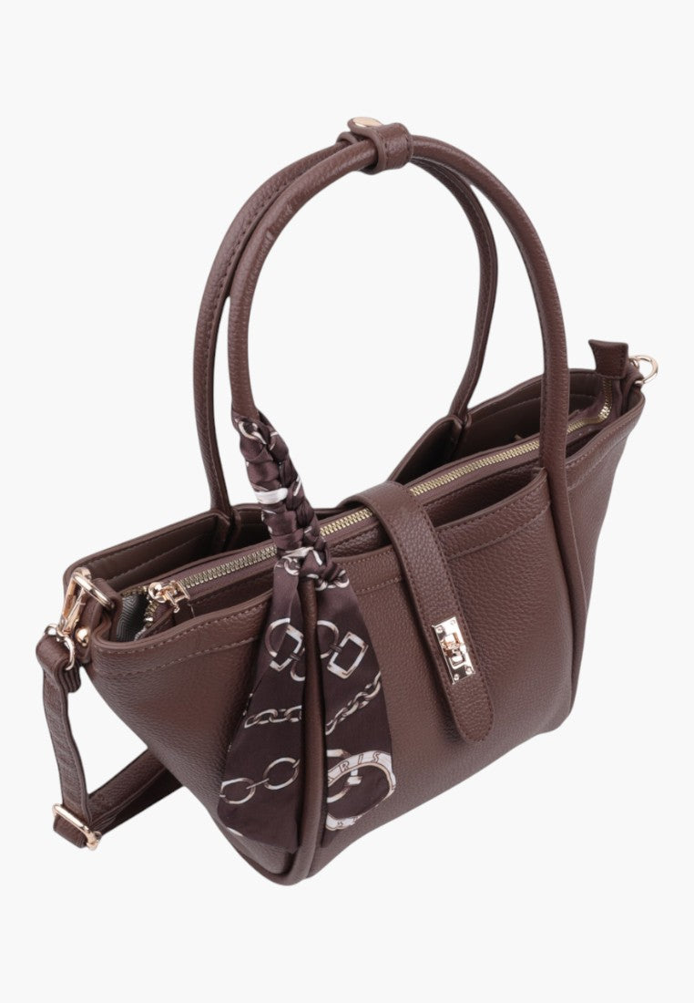 Back view of taupe faux leather shopper handbag with two compartments and decorative scarf.