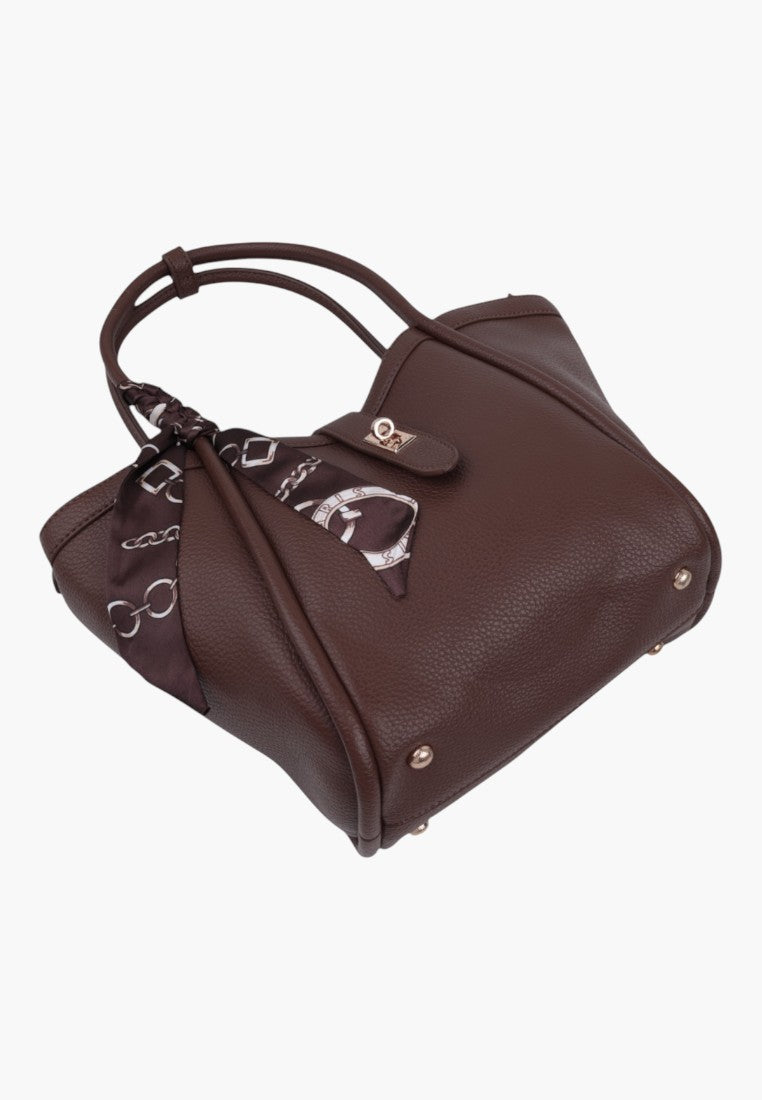 Back view of taupe faux leather handbag with top handles and decorative patterned scarf.